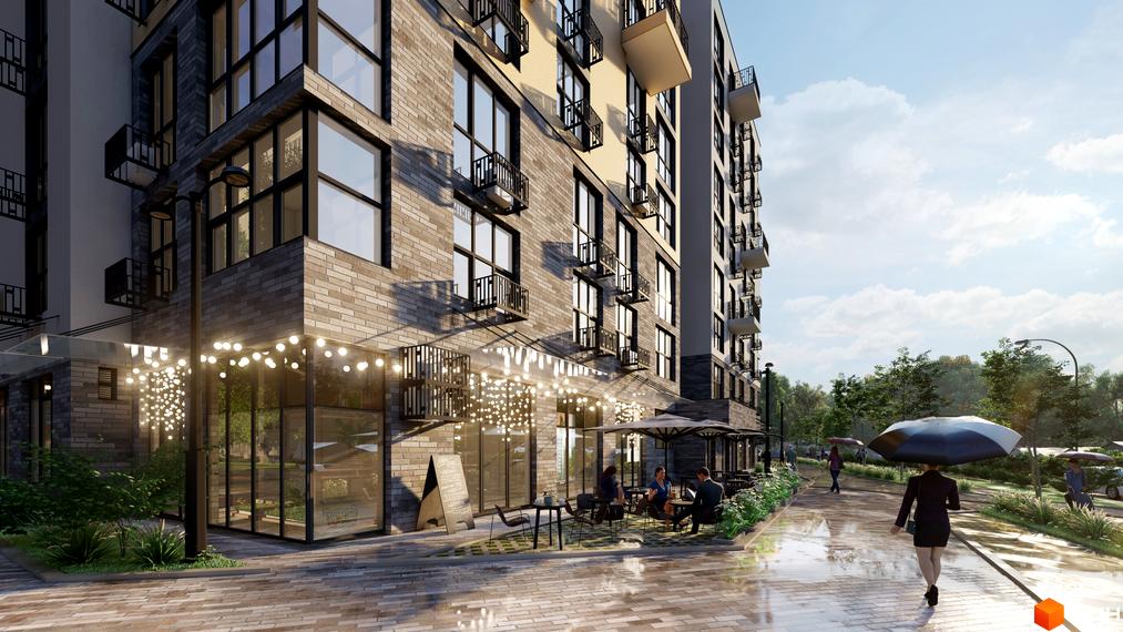 Житловий комплекс TWINS RESIDENCE з цегляним фасадом та терасою з парасолями. Навколо будинку облаштована прибудинкова територія з деревами та пішохідною доріжкою.