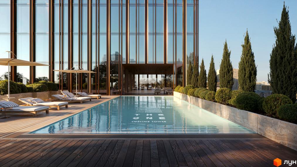 Басейн та зона відпочинку на даху житлового комплексу THE ONE з видом на місто. Сучасна архітектура та зелені насадження створюють затишну атмосферу.