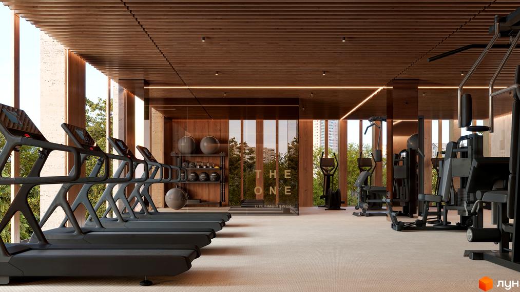 Сучасний фітнес-центр у житловому комплексі THE ONE з тренажерами та зоною для вільних ваг. Великі вікна забезпечують багато природного світла.