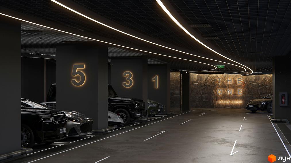 Підземний паркінг житлового комплексу THE ONE з освітленням та номерами паркомісць. На стіні логотип 