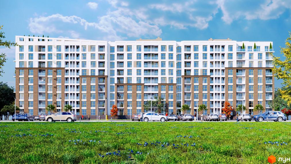 Зовнішній вигляд житлового комплексу Кориця з цегляним та білим фасадом, численними балконами та паркуванням перед будинком. Навколо будинку зелена галявина з квітами та дерева.