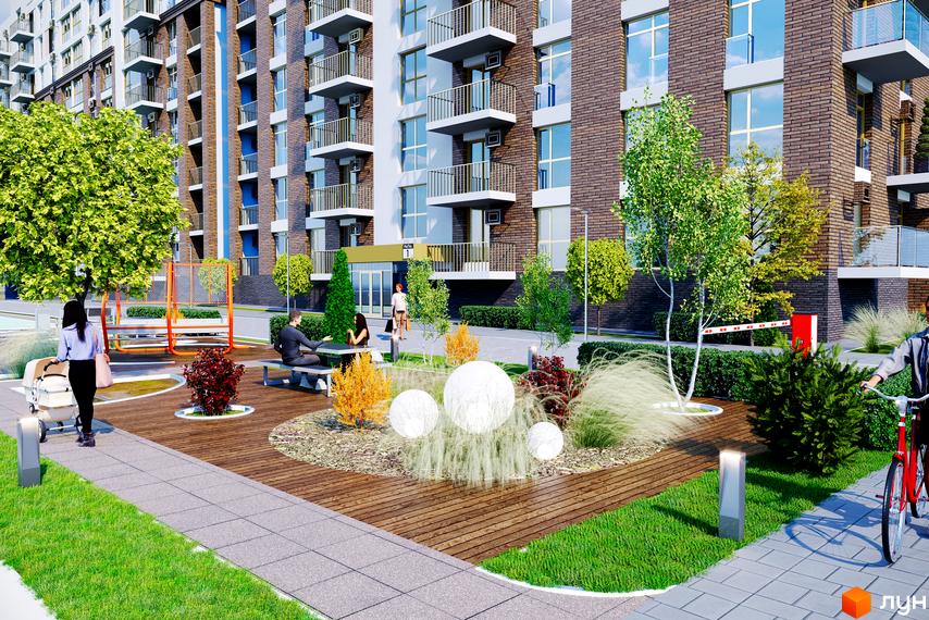 Житловий комплекс Кориця: цегляний будинок з балконами та прибудинкова територія з ландшафтним дизайном, місцями для відпочинку та дитячим майданчиком.