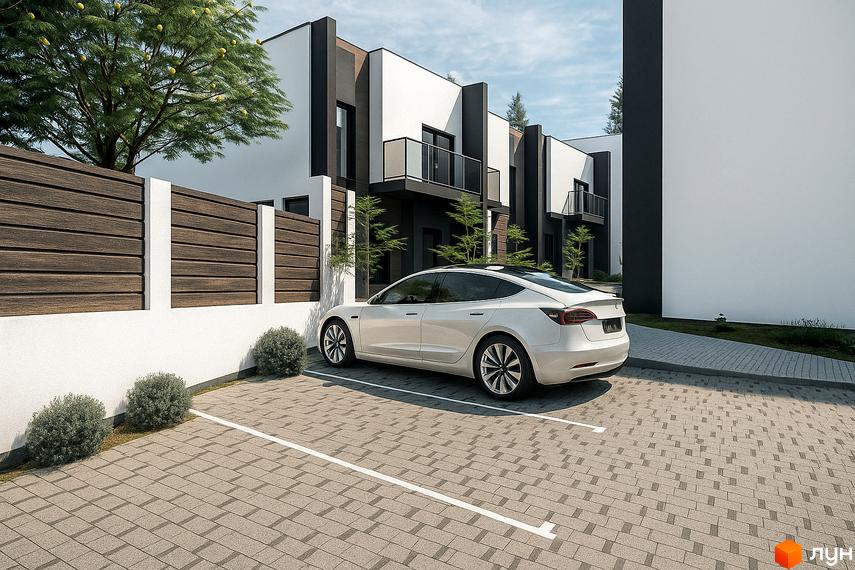 Таунхауси KVARTA з білими фасадами та темними акцентами, парковка з бруківки та зелені кущі.
