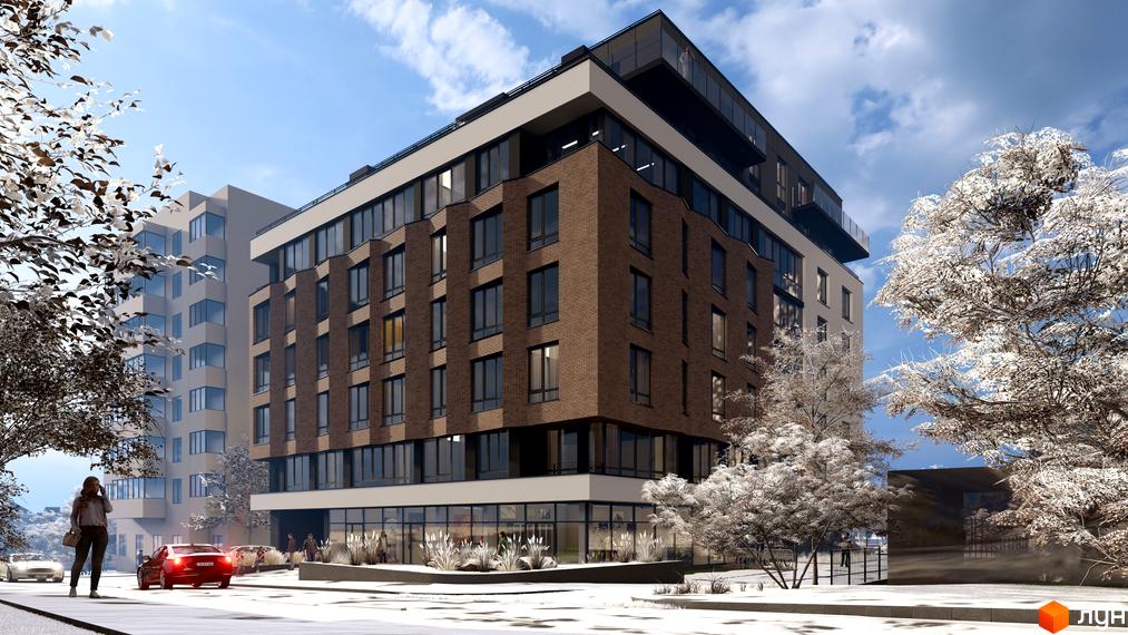 Зовнішній вигляд житлового комплексу Поділля з цегляним фасадом та великими вікнами. Навколо комплексу засніжені дерева та вулиця з автомобілями.