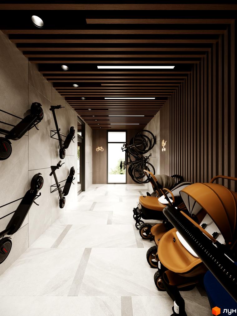 Зберігання самокатів та велосипедів у просторому коридорі житлового комплексу Kaiser Forest. Дитячі візочки зручно розташовані біля виходу.