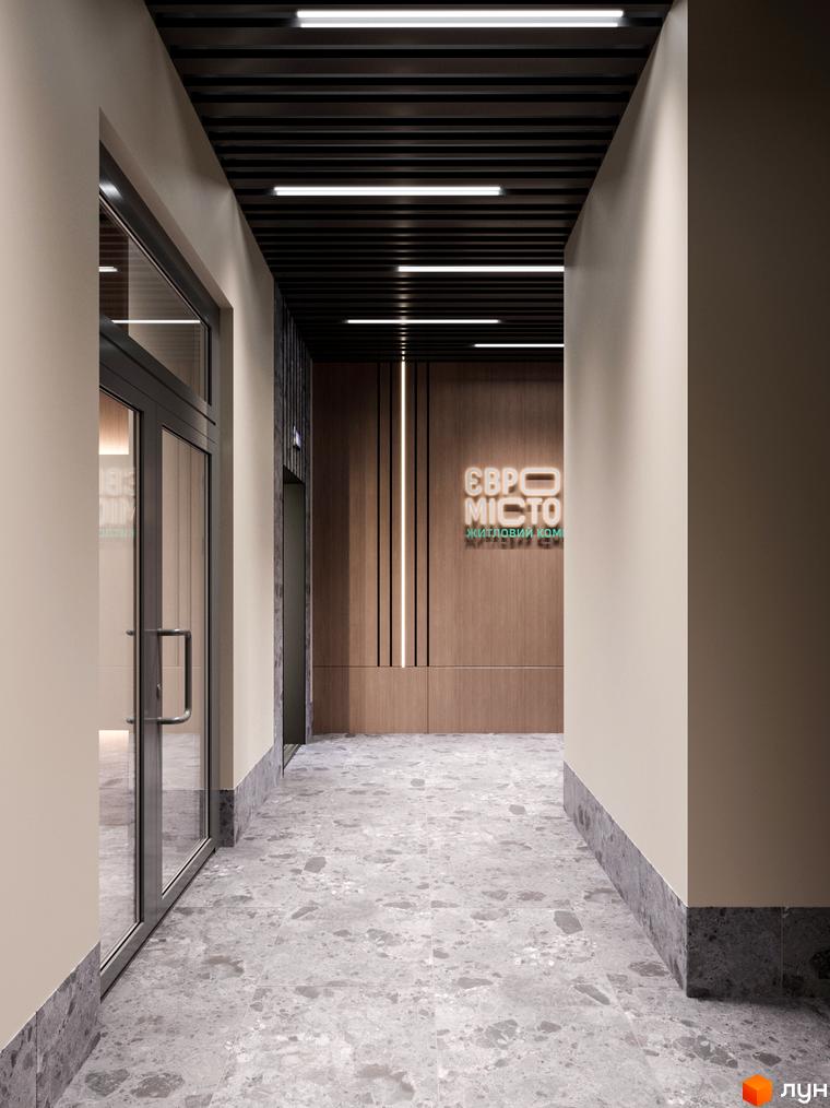 Сучасний вхід у житловий комплекс Євромісто 2 з дверима та ліфтом. Оздоблення стін та підлоги відповідає дизайну новобудови.