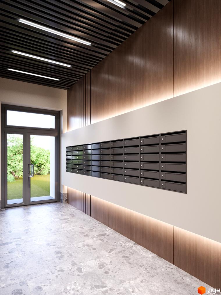 Сучасний вхід у житловий комплекс Євромісто 2 з поштовими скриньками та дверима, що ведуть на зелену прибудинкову територію.