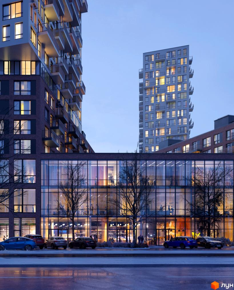 Зовнішній вигляд житлового комплексу The TENTH House з багатоповерховими будинками та скляним фасадом. Навколо будівлі розташовані дерева та припарковані автомобілі.