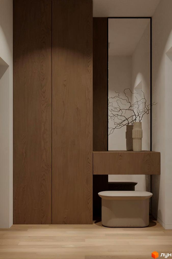 Вітальня з вбудованими шафами кольору темного дерева, дзеркалом та пуфом. Оздоблення стін та підлоги виконано в світлих тонах.