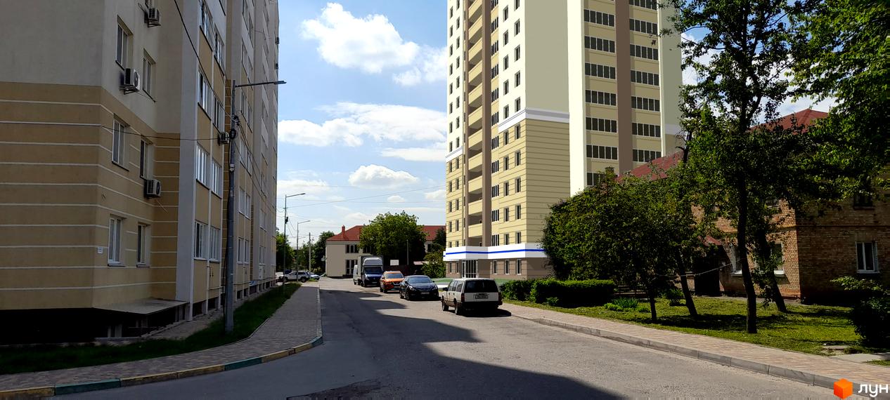 Житловий комплекс Новосілки 2: багатоповерхові будинки з балконами та кондиціонерами, дорога з прибудинковою територією та зеленими насадженнями.