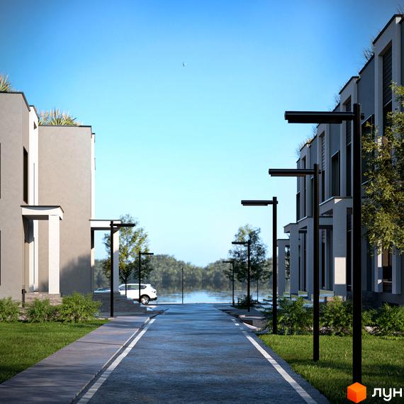 Котеджне містечко КМ The Lake: сірі будинки з пласкими дахами, зелені насадження та сучасне освітлення вздовж дороги до озера.