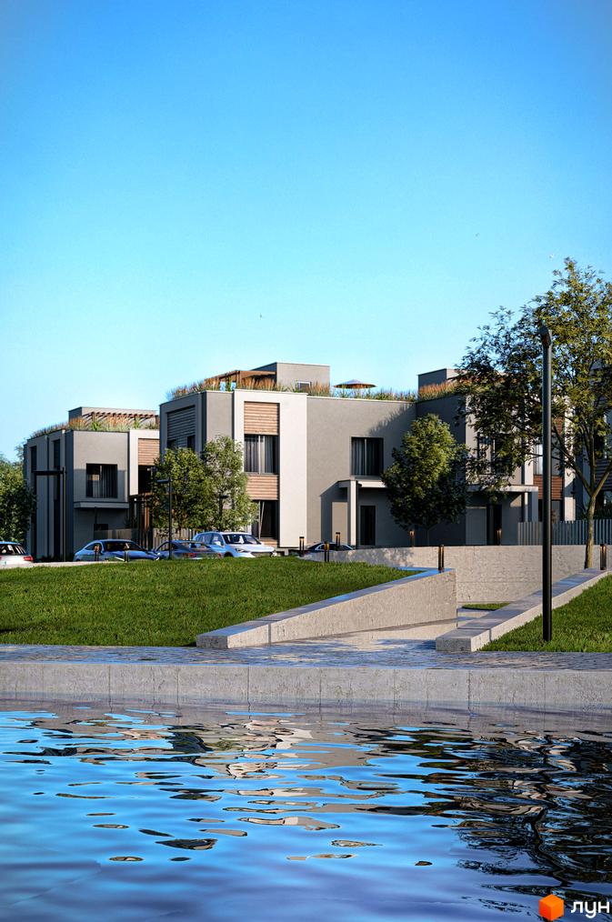 Котеджне містечко КМ The Lake: сірі будинки з дерев'яними елементами та зеленою зоною відпочинку біля води. На території розташовані автомобілі та вуличні ліхтарі.