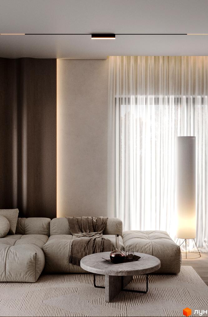 Інтер'єр вітальні в житловому комплексі КМ The Lake з м'якими меблями та кавовим столиком. Сучасне освітлення та панорамні вікна створюють затишну атмосферу.