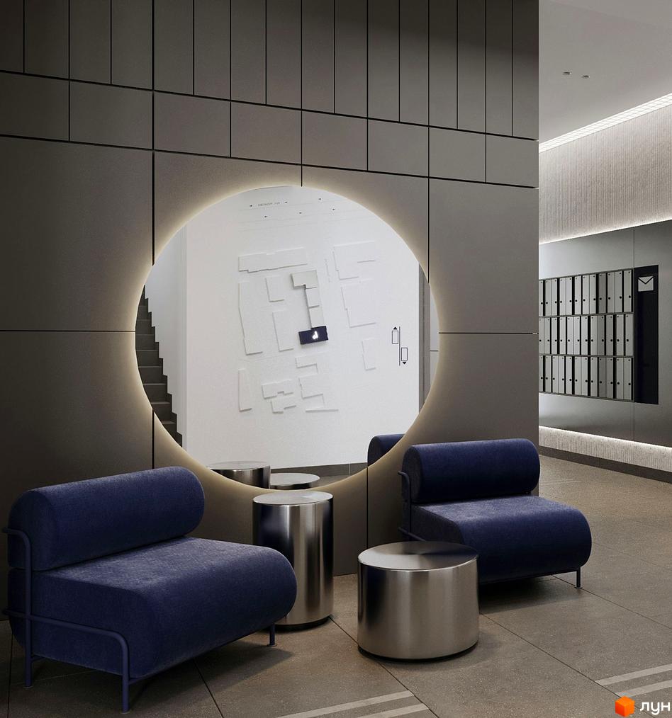 Сучасний хол житлового комплексу Newton з круглим дзеркалом та синіми кріслами. На стіні видно поштові скриньки.
