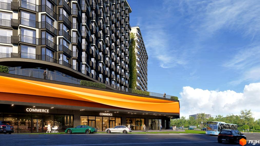 Фасад житлового комплексу з комерційними приміщеннями на першому поверсі. Поруч дорога з автомобілями та автобусом.