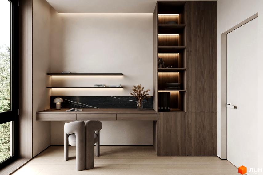 Інтер'єр робочого місця в житловому комплексі КМ NOA з дерев'яними меблями, полицями та зручним кріслом.