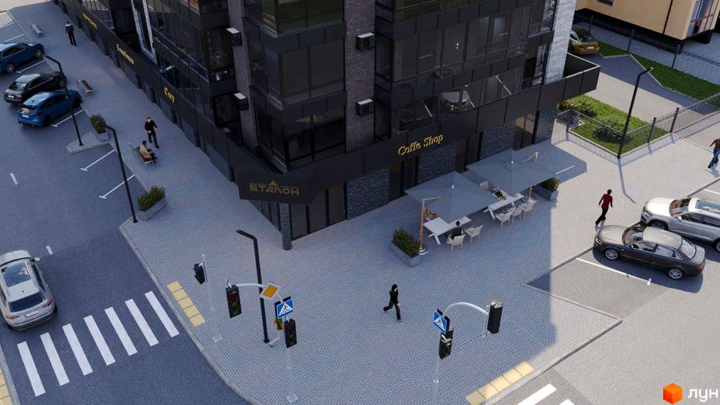 Зовнішній вигляд житлового комплексу бул. Шевченка, 22, з фасадами темного кольору та великими вікнами. Прибудинкова територія з кафе та місцями для паркування.