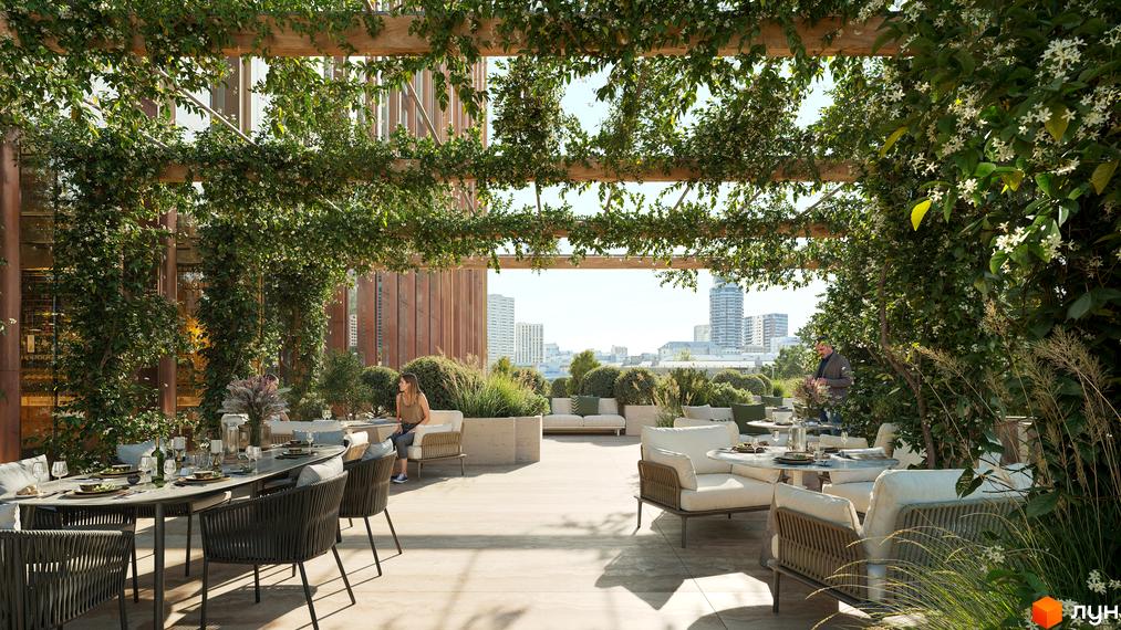 Тераса житлового комплексу THE ONE з обідніми столами та зонами відпочинку, оточена зеленню, з видом на міський пейзаж.