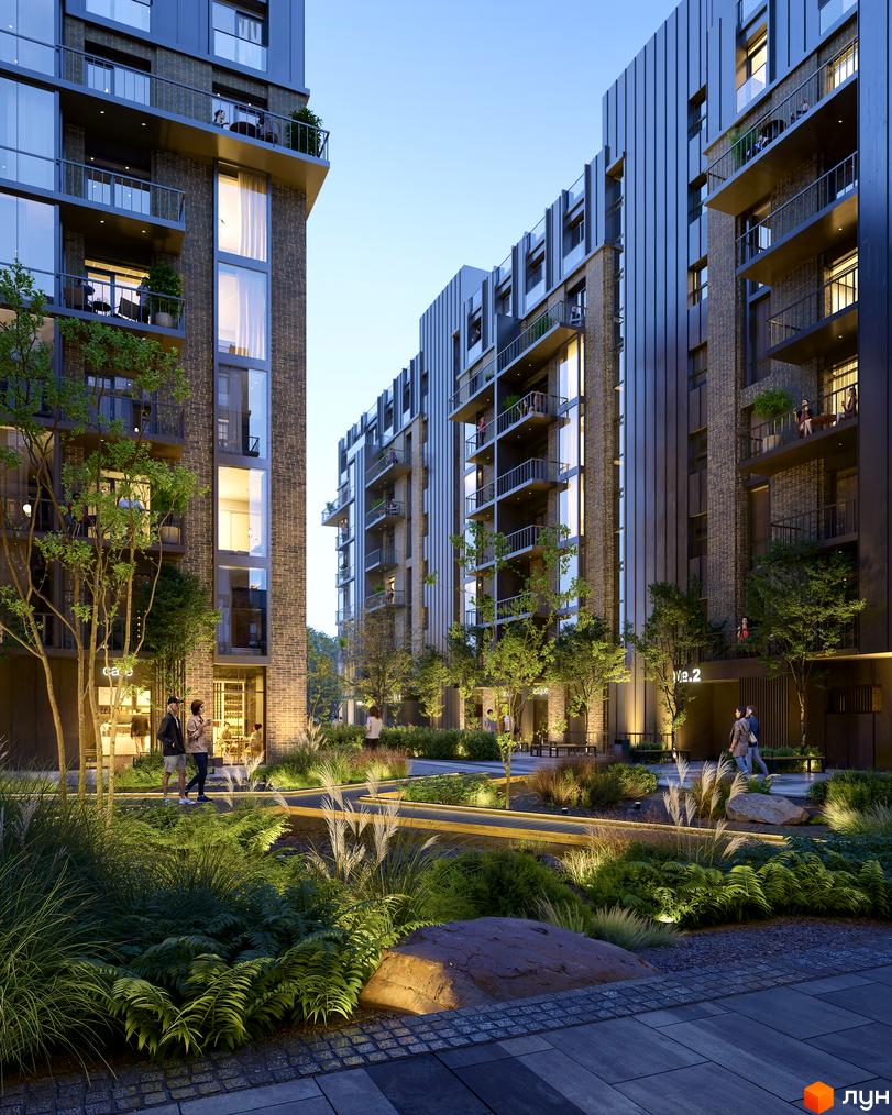 Житловий комплекс Центр: фасади будинків з цегляним оздобленням та балконами, освітлена прибудинкова територія з ландшафтним дизайном.