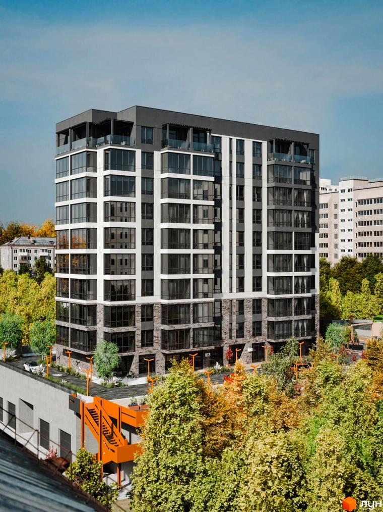 Новобудова ЖК Перемога з панорамними вікнами та балконами, оточена деревами та з облаштованою прибудинковою територією.