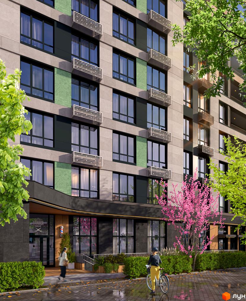 Зовнішній вигляд новобудови ЖК RIVERVILLE з фасадом з сірих плит та зелених вставок, вікнами та балконними блоками. Прибудинкова територія з деревами, кущами та пішохідною доріжкою.