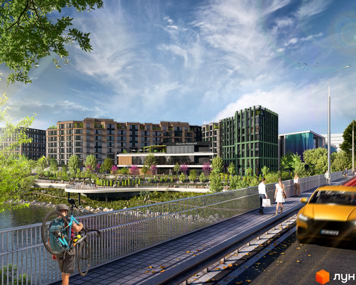 Будівельний проєкт RIVERVILLE з багатоповерховими будинками та зеленою прибудинковою територією біля річки. На зображенні видно міст з пішоходами та велосипедом, а також автомобілі на дорозі.