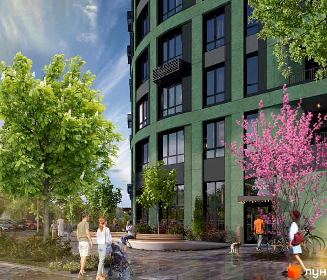 Зовнішній вигляд новобудови ЖК RIVERVILLE з фасадом зеленого кольору та прибудинковою територією з деревами та квітами. Люди гуляють біля будинку.