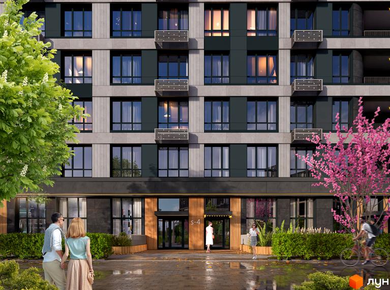 Житловий комплекс RIVERVILLE з фасадами з сірого каменю та темних панелей, з балконами та великими вікнами. Перед будинком розташована прибудинкова територія з кущами та деревами, а також люди, що прогулюються.