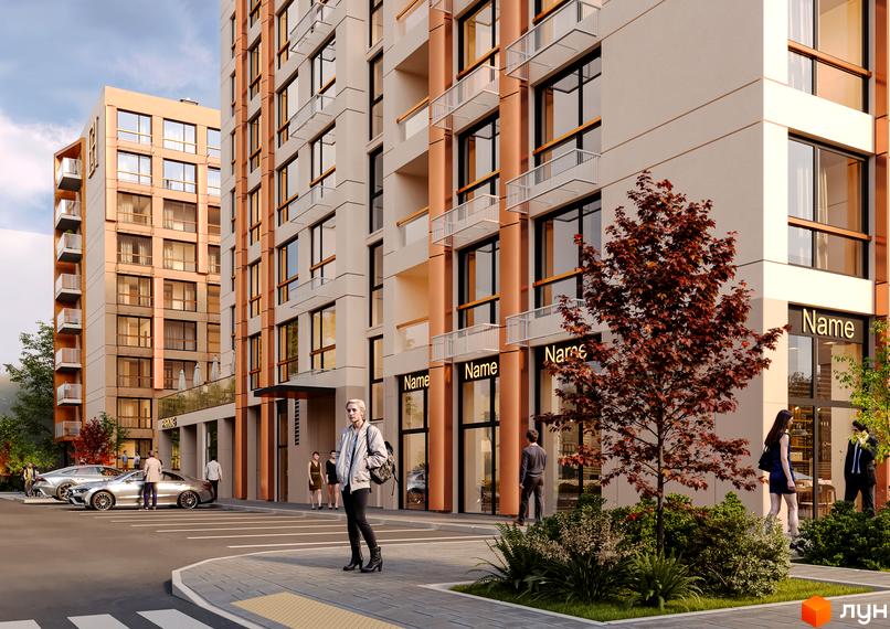 Новобудова Estet Hill з фасадами бежевого та помаранчевого кольорів, скляними балконами та комерційними приміщеннями на першому поверсі. Поруч парковка та зелені насадження.