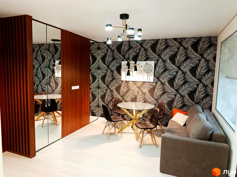 Інтер'єр квартири в житловому комплексі Вертикаль з обідньою зоною та диваном. Сучасне оздоблення стін та підлоги.