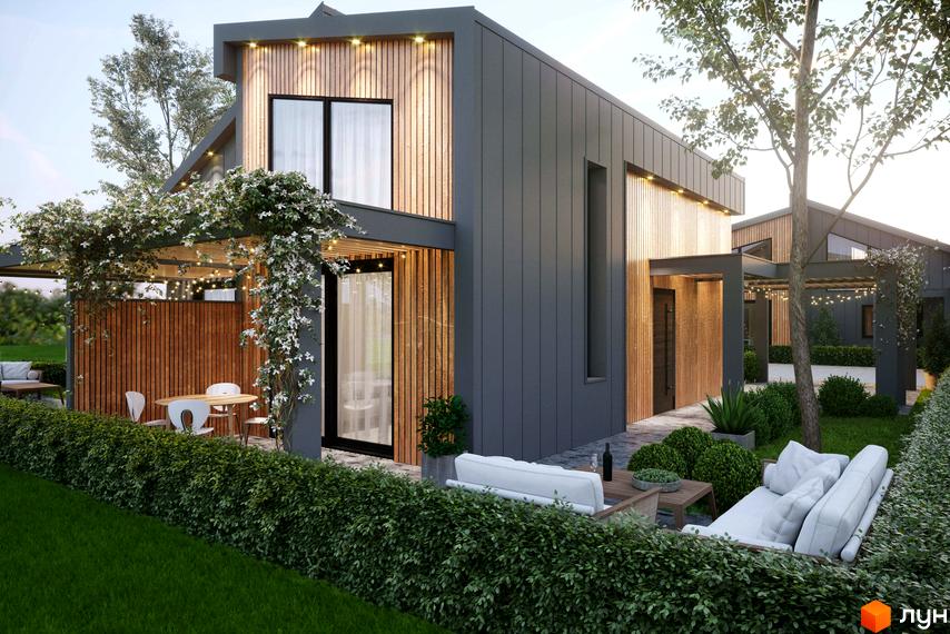 Зображення будинку в Котеджному містечку Gross Liebental з дерев'яним оздобленням та зоною відпочинку на прибудинковій території.