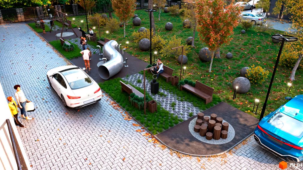 Вигляд зверху на Житловий комплекс Family Park з ігровим майданчиком, лавками та парковкою для автомобілів.
