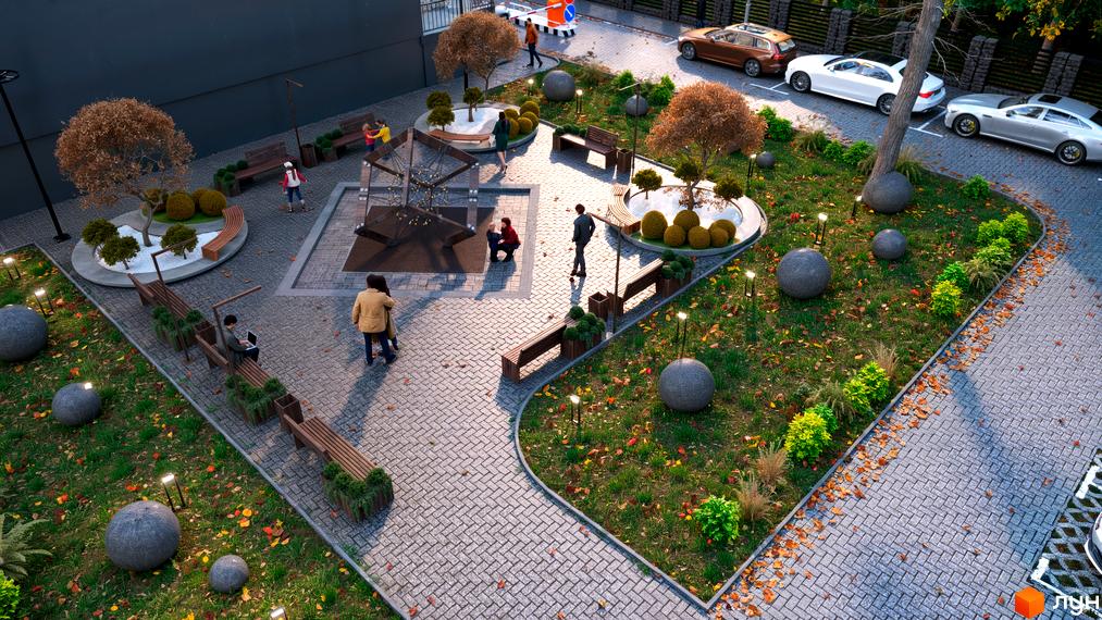 Зображення Житлового комплексу Family Park з виглядом на дитячий майданчик, ландшафтний дизайн та парковку.
