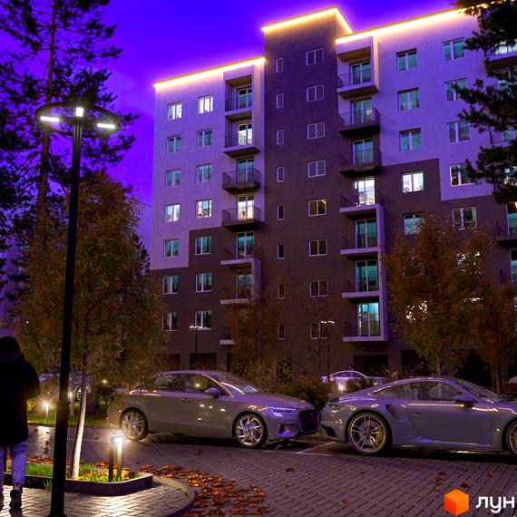 Зображення фасаду багатоповерхового будинку в Житловому комплексі Family Park з освітленням та припаркованими автомобілями.