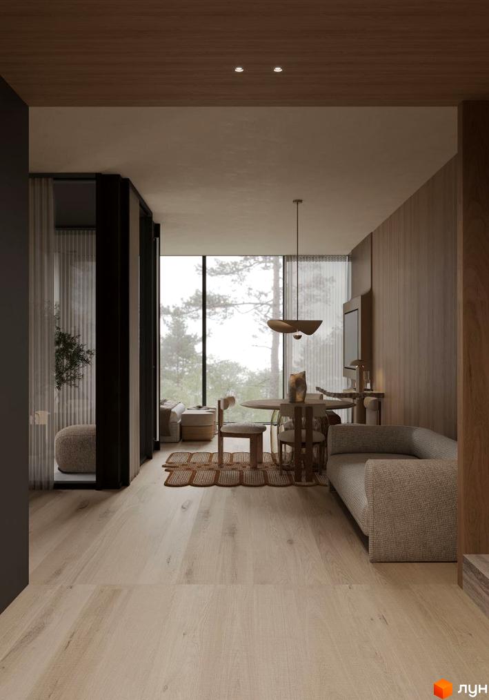 Інтер'єр апарт-комплексу Crystal Hills з видом на ліс. Зручний диван, круглий столик та великі вікна з чудовим краєвидом.