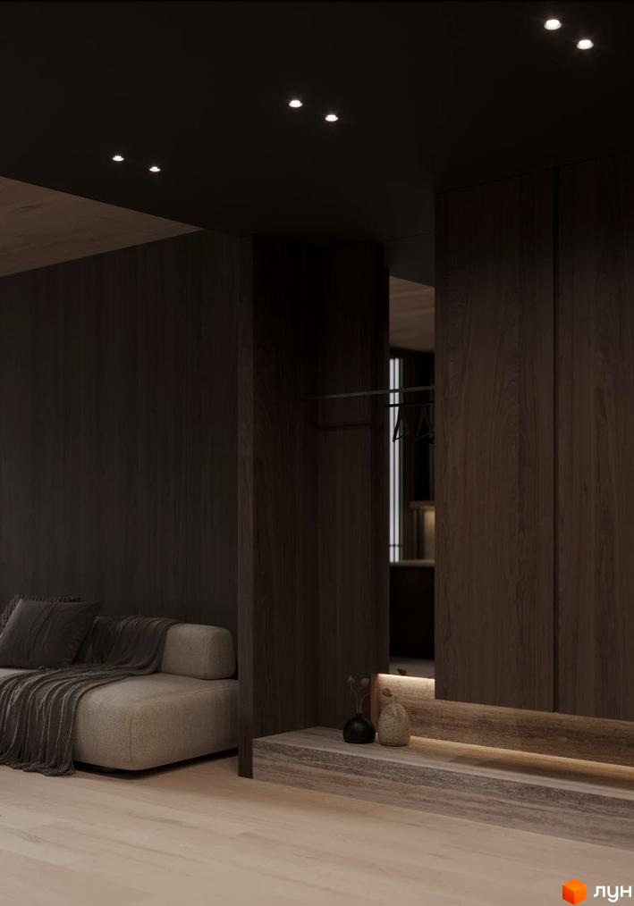 Інтер'єр апартаментів в Crystal Hills з темними дерев'яними панелями та м'яким диваном. Стельові світильники забезпечують приглушене освітлення.