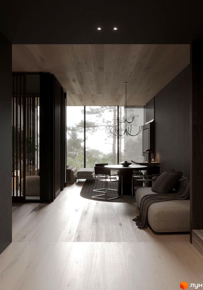 Інтер'єр апартаментів в Crystal Hills з великим вікном та видом на ліс. Вітальня з диваном та обідньою зоною.