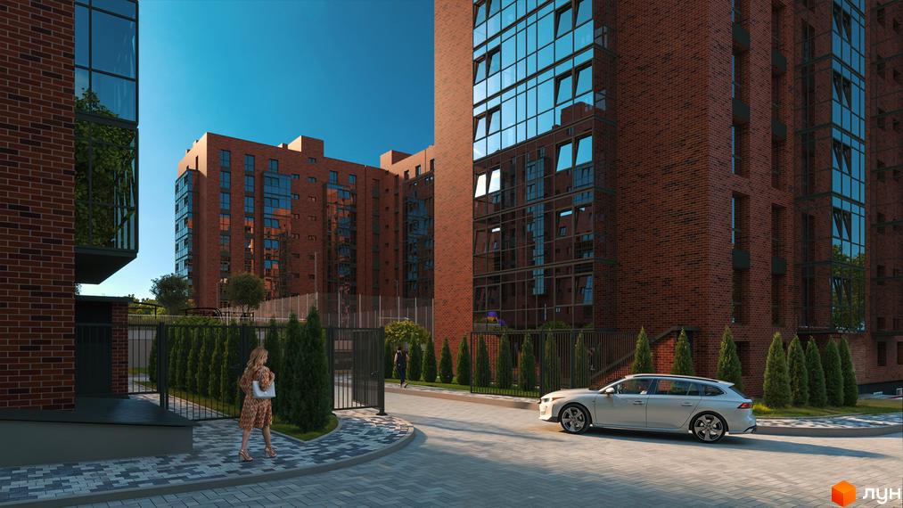 Вигляд фасаду та прибудинкової території Житлового комплексу Standard. Цегляні багатоповерхівки з великими вікнами та зелені насадження.