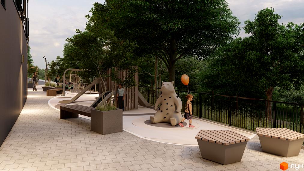 Дитячий майданчик біля житлового комплексу Emily Apartments з гірками, гойдалками та скульптурою ведмедя. Територія навколо вимощена плиткою, оточена деревами та огороджена парканом.