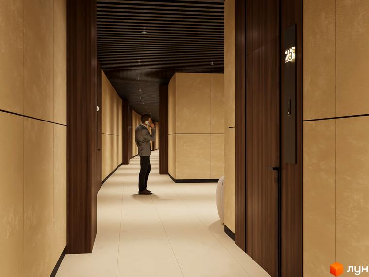 Інтер'єр коридору в житловому комплексі Emily Apartments з дверима та освітленням. Чоловік розмовляє по телефону в коридорі.