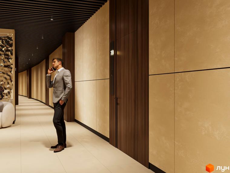 Чоловік у діловому костюмі розмовляє по телефону у сучасному коридорі ЖК Emily Apartments. Оздоблення стін - дерево та світлий камінь.
