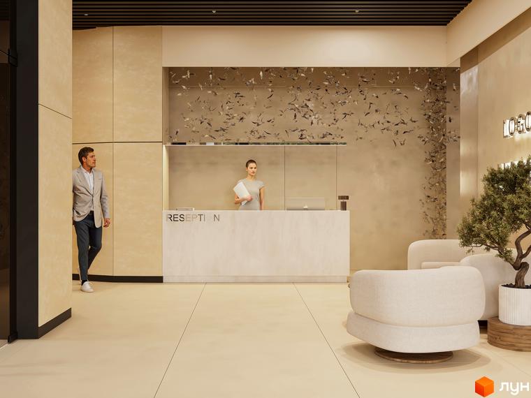 Ресепшн в ЖК Emily Apartments з чоловіком, що йде повз. Інтер'єр лобі з диванами та деревом.