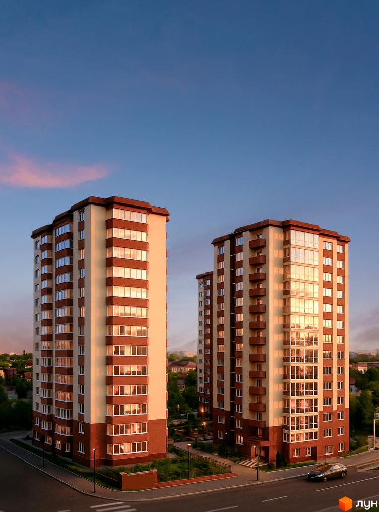 Житловий комплекс Нова Європа: два висотних будинки з червоно-бежевими фасадами та скляними балконами. Навколо зелена територія з доглянутими газонами та дорогою.