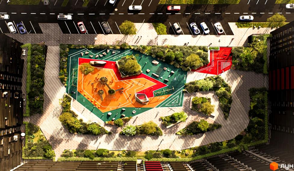 Комплекс Family Plaza 2 з яскравим дитячим майданчиком та зонами відпочинку. Навколо комплексу розташовані зелені насадження та парковка.