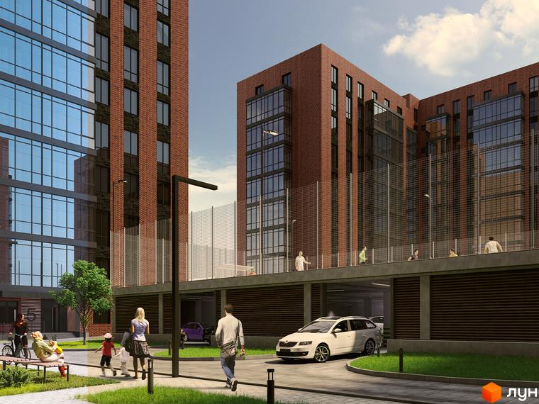 Зовнішній вигляд новобудови ЖК Стандарт з цегляним фасадом та скляними елементами, прибудинкова територія з парковкою та зеленими зонами.