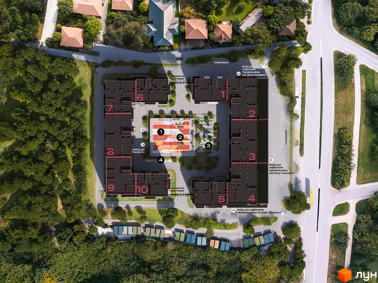 Аерофотозйомка житлового комплексу Стандарт з висоти пташиного польоту, що демонструє будівлі та внутрішній двір з дитячим майданчиком.