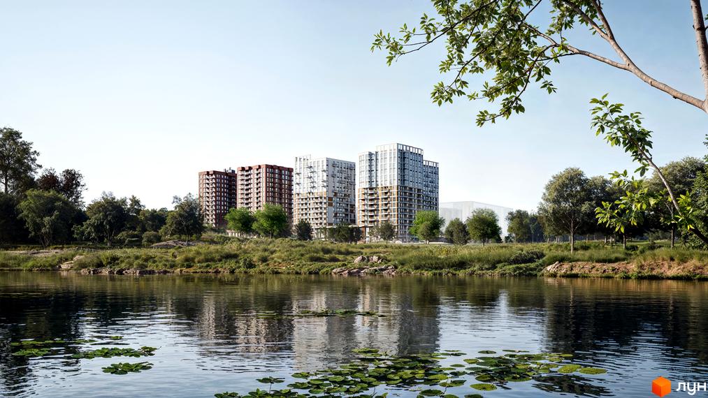 Житловий комплекс Озерні Вежі з цегляними та білими фасадами, розташований біля озера з зеленою зоною та деревами.