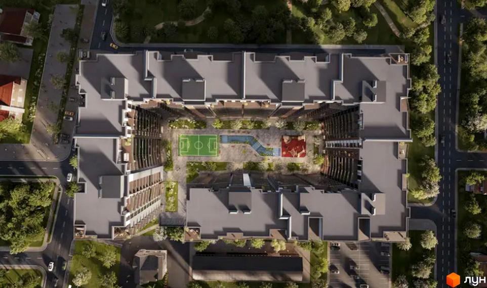 Житловий комплекс Etalon Gold з висоти пташиного польоту, що демонструє його унікальну П-подібну форму та внутрішній двір з футбольною полем та дитячим майданчиком.