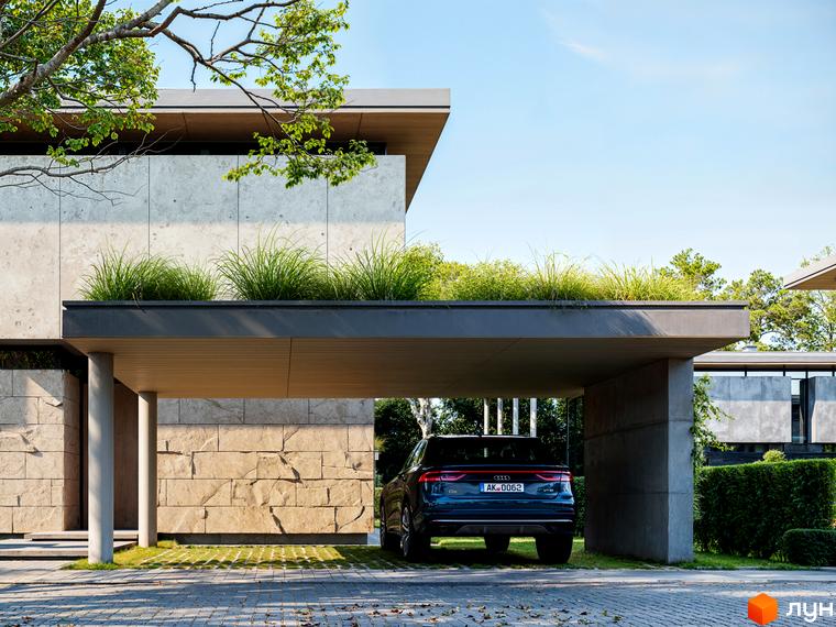 Котеджне містечко КМ UNIQUE: фасад будинку з бетону та каменю, зелена покрівля. Прибудинкова територія з навісом для авто та газоном.