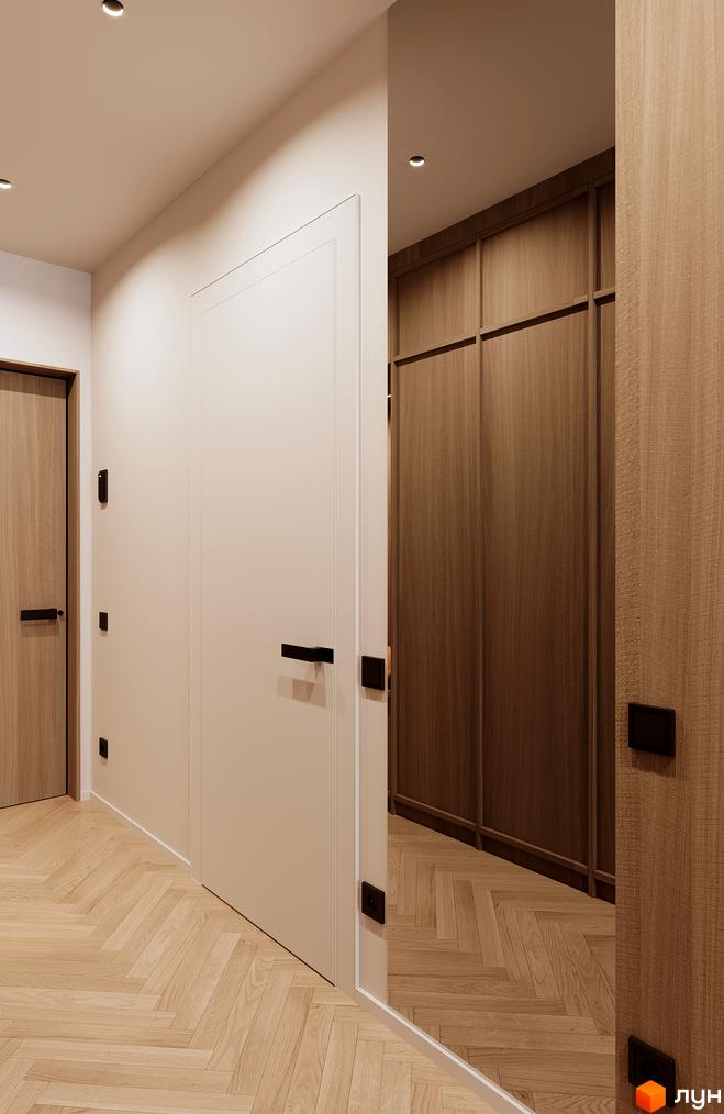 Інтер'єр холу новобудови Standard One Позняки з дерев'яними елементами та білими дверима. Паркетна підлога викладена 
